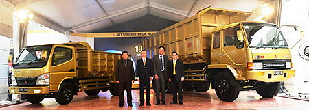 MFTBC and KTB Executives celebrating its success with Canter “Colt Diesel” (left) and FM (right) trucks